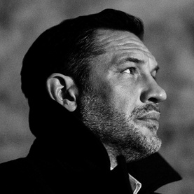 Man in profile gazing upward in dramatic black and white lighting, evoking the mood of Jo Malone Cypress & Grapevine Cologne Intense