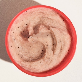 Sol De Janeiro Dom Dia Bright Body Scrub in coral pot, overhead view showing pink exfoliating scrub texture with dark specks