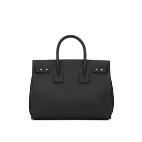 Saint Laurent Sac de Jour Supple Small Leather Bag in black calf leather with gold-toned hardware, dual top handles, and snap button tabs