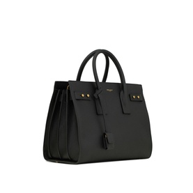 Saint Laurent Sac de Jour Supple Small Leather Bag in black calf leather with gold-toned hardware, dual top handles and side buckle straps