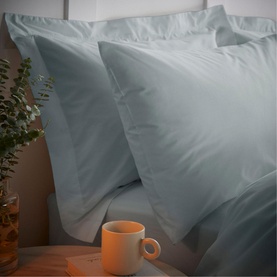 Bianca 200 Thread Count Cooling Tencel Duvet Set in silver, showing plump pillows with a subtle sheen, styled with a mug and eucalyptus plant