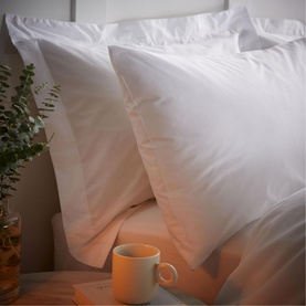 Bianca 200 Thread Count Cooling Tencel Duvet Set in white, styled with matching pillowcases, a mug and eucalyptus plant on a bed