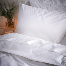Bianca 200 Thread Count Cooling Tencel Pillowcase Pair in white, styled on a bed with soft warm lighting and eucalyptus in background