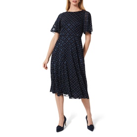 Model wearing Hobbs Ciera Spot Print Midi Dress in blue, flutter sleeves, round neckline, polka dot pattern, styled with navy heels