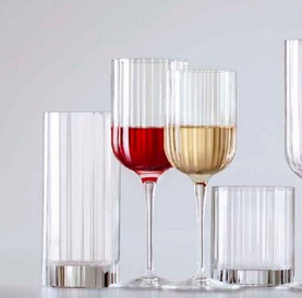 Luigi Bormioli Bach Red Wine Glass filled with red wine, styled alongside white wine and tall highball glasses in ribbed crystal