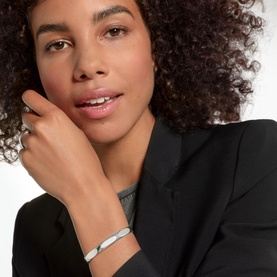 Model with Thomas Sabo Minimalist Silver Bangle in sterling silver, curved solid design, styled with black blazer and ring