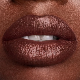 Est&eacute;e Lauder Pure Color Cr&egrave;me Lipstick in Strut, a deep chocolate-brown shade with a satin finish, shown on lips