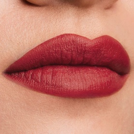 Est&eacute;e Lauder Pure Color Matte Lipstick in Rule Maker, a deep burgundy-red shade, shown worn on lips with a matte finish