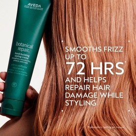 AVEDA Botanical Repair Bond-Building Styling Cr&egrave;me 40ml held near model's smooth, frizz-free auburn hair with styling benefit text overlay