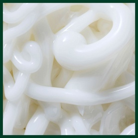 Aveda Botanical Repair Bond-Building Styling Cr&egrave;me shown on defined white wavy hair strands, demonstrating smoothing and bond-building results