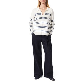 Model wearing Hobbs Jacqui Wide Leg Trousers in blue, high-waisted with tie belt, styled with a white navy stripe knit polo top