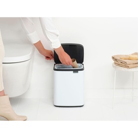 Brabantia Bo Waste Bin 7L in White with open lid, shown in use in a bathroom setting beside a toilet