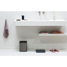 Brabantia Bo Waste Bin 7L in Platinum silver, shown in a minimal bathroom setting beside a white wall-mounted sink