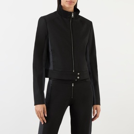 Model wearing Diesel Gauri Short Wool-Blend Zip-Through Jacket in black, with stand-up collar and zip fastening, styled with matching black trousers