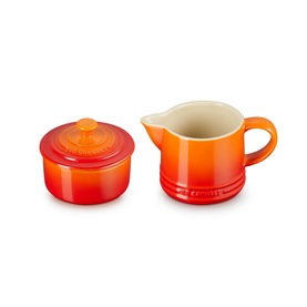 Le Creuset Stoneware Milk & Sugar Set in orange, featuring a lidded sugar bowl and milk jug with cream interior finish