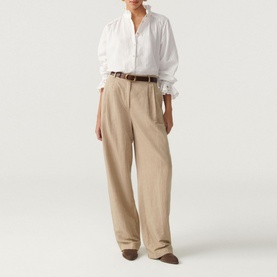 Model wearing Bash Feely Shirt in cream, embroidered cotton-linen blend, styled with wide-leg beige trousers and a brown belt
