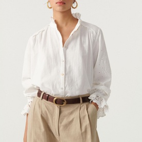 Model wearing Bash Feely Shirt in cream with embroidered sleeve detail, styled with tan trousers and brown leather belt