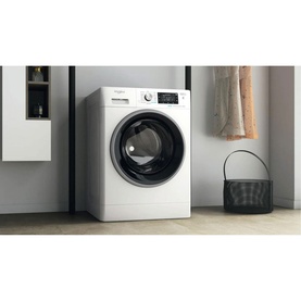 Whirlpool Black Line Freshcare 10Kg 1400 Spin washing machine in white with black door trim, shown in a styled laundry room setting