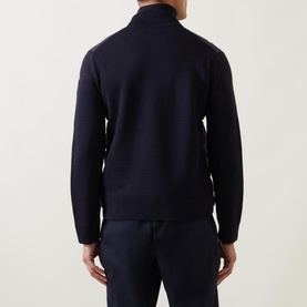 Model wearing Moncler Padded Quilted Zip Cardigan in navy, back view, high collar, paired with navy trousers