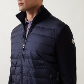Model wearing Moncler Padded Quilted Zip Cardigan in navy, featuring quilted front, knitted sleeves, high collar and logo patch