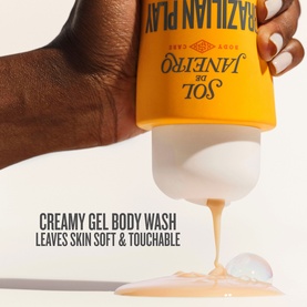 Sol de Janeiro Brazilian 4 Play Moisturising Shower Cream-Gel being squeezed, showing creamy gel texture pouring from yellow bottle