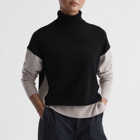 Model wearing Reiss Alexis Colour-Block Sweater in beige, black and stone colourblock roll-neck with dropped shoulders and rib-knit finishes