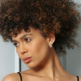 Model with Newbridge Double Flower Crystal Embellished Stud Earrings in silver, featuring cubic zirconia centres and polished finish