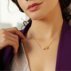 Model with Newbridge Yellow & White Floral Pendant Necklace; cluster daisy design with white and yellow enamel on gold-toned chain