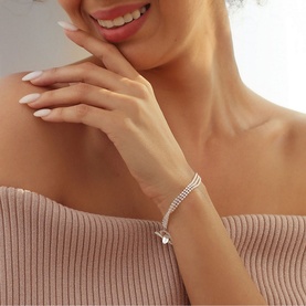 Model with Newbridge Embellished Triple Strand Bracelet in silver, featuring triple-row cubic zirconia settings and T-bar fastening