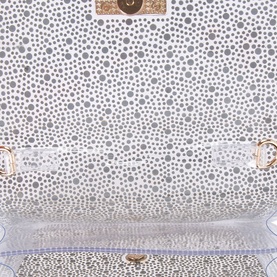 Carvela Lovebird Jewel Clutch in gold, showing spotted fabric lining interior with gold-tone hardware clasp detail visible at top