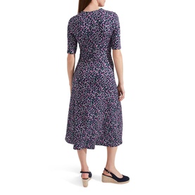 Model wearing Hobbs Frankie Printed V-Neck Midi Dress in blue floral print, short sleeves, shown from behind, styled with navy wedge espadrilles