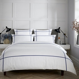 Karla Bree 400 Thread Count Criss Cross Duvet Set in Navy, white cotton bedding with navy embroidered border detail, styled on a double bed