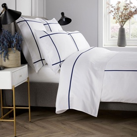 Karla Bree 400 Thread Count Criss Cross Duvet Set in white with navy embroidered grid pattern, styled on a bed with matching pillowcases