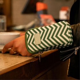 Dust and Rock The Original Wrist Pocket Mini Coillte purse in green and white chevron stripe nylon with zip closure, worn on wrist
