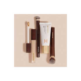 Hourglass Veil Hydrating Skin Tint 35ml foundation tube with concealer pen and two makeup brushes on neutral background