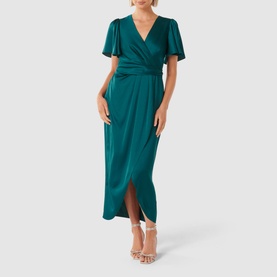 Model wearing Forever New Estelle Satin Flutter Sleeve Midi Dress in green, with wrap front and flutter sleeves, styled with nude heeled sandals