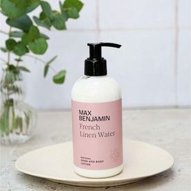Max Benjamin Natural Hand Lotion French Linen Water 300ml in white pump bottle with pink label, styled on ceramic dish with greenery