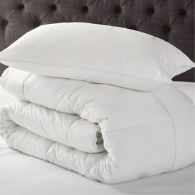 Dreamworld Duck Feather & Down Duvet 10.5 Tog in white, folded and styled with a matching white pillow on a bed