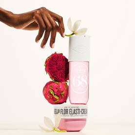 Sol De Janeiro Beija Flor Elasti-Cream body cream bottle styled with tropical dragon fruit and white flowers