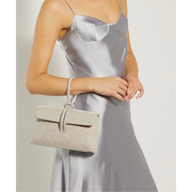 Model carrying Dune Brynie Diamante-Loop-Handle Grab Bag in metallic silver with all-over diamante embellishment and loop handle
