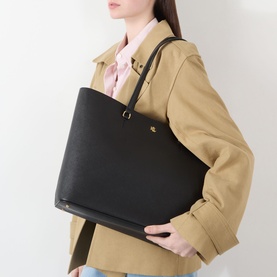 Model carrying Lauren Karly Large Tote Bag in black crosshatch leather with gold-tone hardware, styled with a camel coat and pink scarf