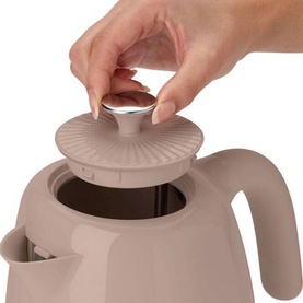 Kenwood Elegancy Black Treacle Kettle in beige, close-up of lid being opened by hand, showing ribbed detail and silver knob