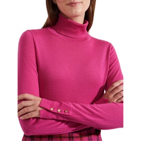 Model wearing Hobbs Lara Roll Neck Sweater in pink merino wool, featuring roll neckline, long sleeves and gold button cuff detail