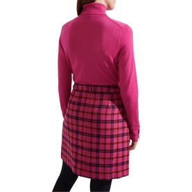 Model wearing Hobbs Lara Roll Neck Sweater in pink with long sleeves and ribbed trims, styled with a pink tartan mini skirt