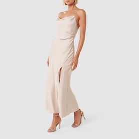 Model wearing Forever New Remy Tie-Back Satin Dress in cream, featuring cowl neckline, spaghetti straps and draped maxi skirt with side split