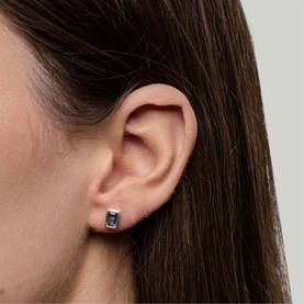 Model with Juvi Manhattan Iolite Stud Earrings in blue, featuring a rectangular iolite gemstone in a polished sterling silver setting