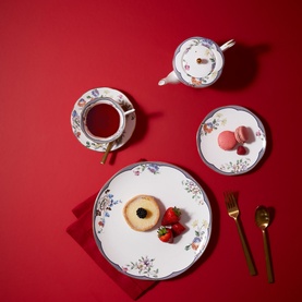 Wedgwood Fortune Teacup Saucer 150ml in multi floral pattern, shown with matching dinner plate, side plate, teapot, gold cutlery