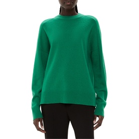 Model wearing Whistles Knit Sweater in green wool, featuring high round neck, ribbed trims and long sleeves, styled with black trousers