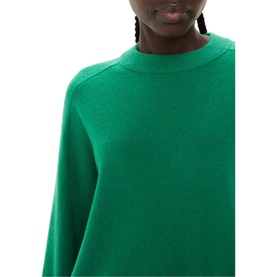 Model wearing Whistles Knit Sweater in green, showing high round neck and relaxed fit, 100% wool