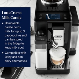 Delonghi Rivelia Automatic Compact Bean To Cup in black with LatteCrema Milk Carafe attachment, dispensing a cappuccino into a glass cup.